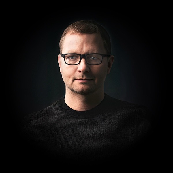 Portraitfoto von Andreas Jobst mit dunklem Hintergrund.